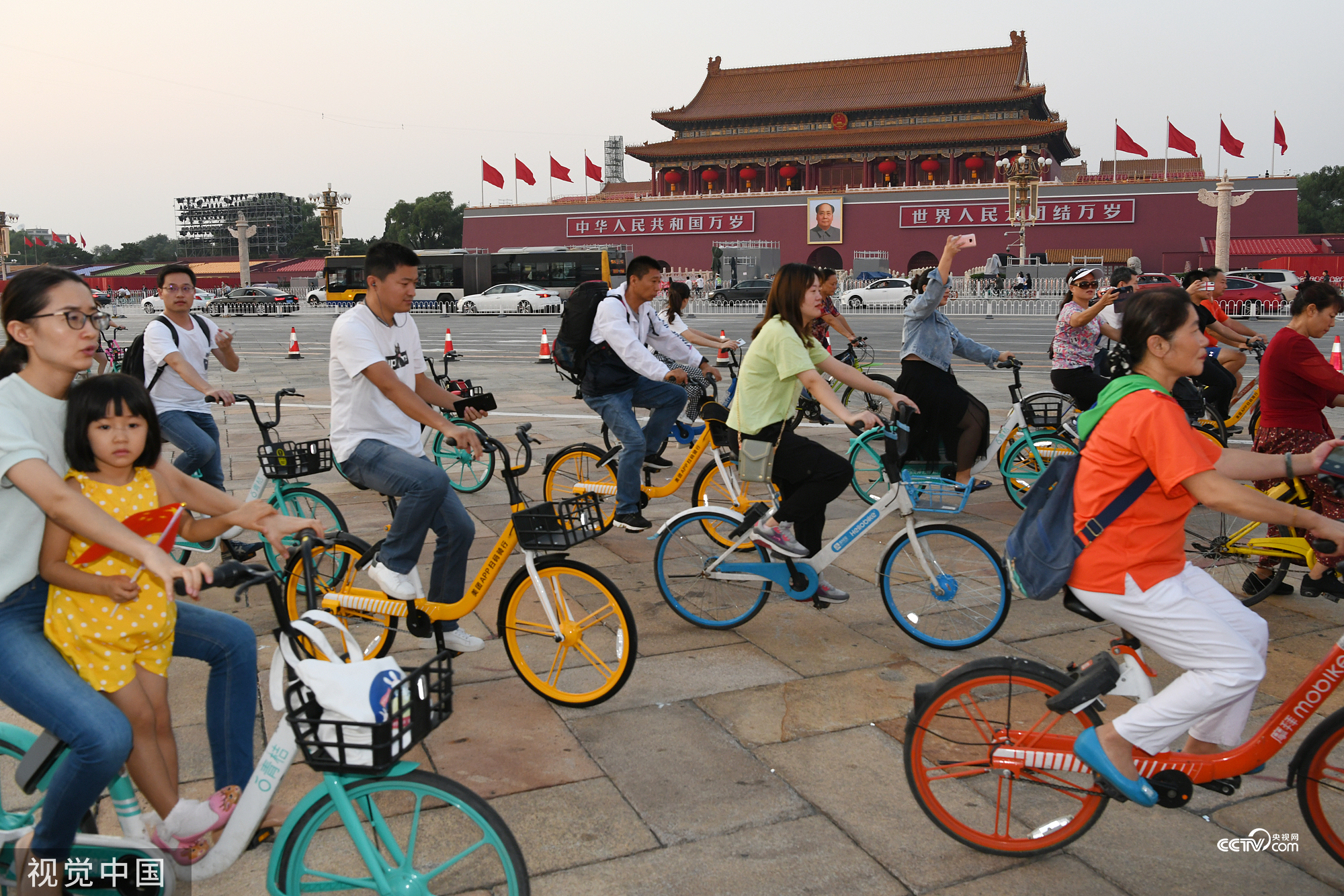 Chinese commuters ride bicycles passing through the Tian’anmen Square in Beijing on a September morning in 2019.