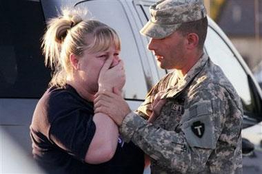 Sgt.&nbsp;Anthony&nbsp;Sills,&nbsp;right,&nbsp;comforts&nbsp;his&nbsp;wife&nbsp;as&nbsp;they&nbsp;wait&nbsp;outside&nbsp;the&nbsp;Fort&nbsp;Hood&nbsp;Army&nbsp;Base&nbsp;near&nbsp;Killeen,&nbsp;Texas&nbsp;on&nbsp;Thursday,&nbsp;Nov.&nbsp;5,&nbsp;2009.(AP&nbsp;Photo/Jack&nbsp;Plunkett)