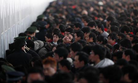 Passengers queue to buy train tickets to go home at the Shanghai Railway Station January 26, 2010.[Photo/Agencies]