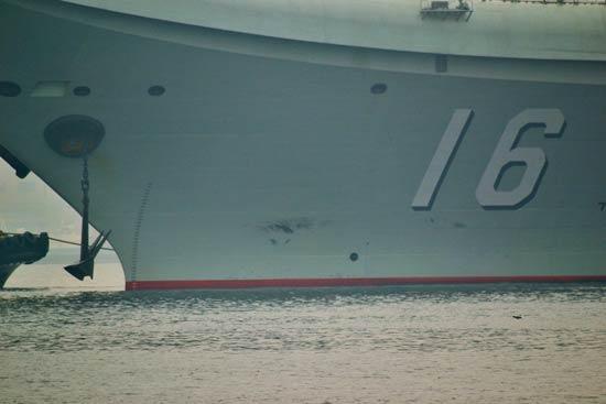 China's first aircraft carrier, the Liaoning, anchored for the first time in a military port in Qingdao, eastern Shandong province on Wednesday morning.