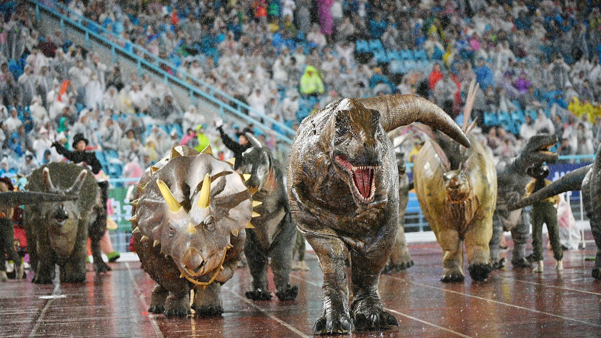 Dino invasion delights crowd at Chinese football match