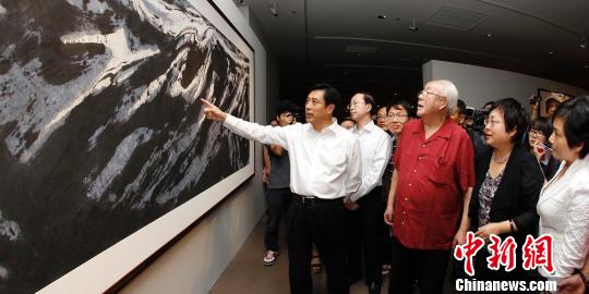 著名艺术家周韶华（前左二）陪同文化部副部长董伟（前左一）等参观展览。　钟欣　摄