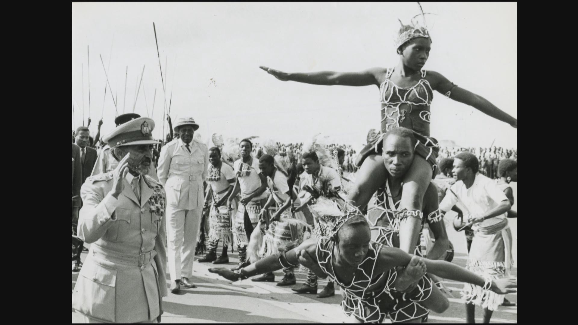 Emperor Haile Selassie salutes the entertainers.