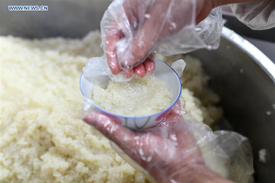 A worker makes eight-treasure rice pudding at a workshop in Zunyi, southwest China