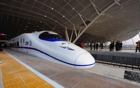 A high-speed train runs out of the Wuhan Railway Station in Wuhan, capital of central China's Hubei Province, Dec. 26, 2009. The Wuhan-Guangzhou high-speed railway, which boasts of the world's fastest train journey with a 350-km-per-hour average speed, is debuted on Saturday. (Xinhua/Cheng Min)