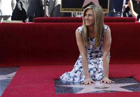 Actress Jennifer Aniston touches her star after it was unveiled on the Walk of Fame in Hollywood, California February 22, 2012.
