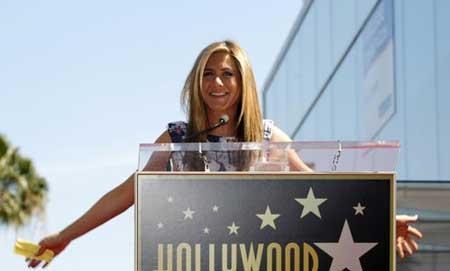 Actress Jennifer Aniston touches her star after it was unveiled on the Walk of Fame in Hollywood, California February 22, 2012.