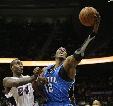 Orlando Magic's Dwight Howard (12) is fouled by Atlanta Hawks' Marvin Williams in the fourth quarter of an NBA basketball game Wednesday, March 24, 2010 in Atlanta.(AP Photo/John Bazemore)