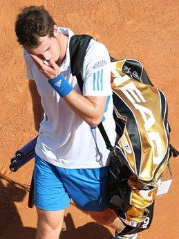 Britain's Andy Murray leaves the court after being defeated by Philipp Kohlschreiber of Germany in his second round match of the Monte Carlo Tennis Masters tournament in Monaco, Wednesday, April 14 , 2010.(AP Photo/Lionel Cironneau)