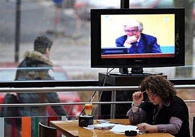 A&nbsp;person&nbsp;reads&nbsp;as&nbsp;a&nbsp;television&nbsp;set&nbsp;braodcasts&nbsp;a&nbsp;live&nbsp;transmission&nbsp;of&nbsp;the&nbsp;trial&nbsp;of&nbsp;wartime&nbsp;Bosnian&nbsp;Serb&nbsp;leader&nbsp;Radovan&nbsp;Karadzic&nbsp;during&nbsp;his&nbsp;first&nbsp;court&nbsp;appearance&nbsp;since&nbsp;the&nbsp;start&nbsp;of&nbsp;his&nbsp;genocide&nbsp;trial&nbsp;at&nbsp;International&nbsp;Criminal&nbsp;Tribunal&nbsp;for&nbsp;the&nbsp;former&nbsp;Yugoslavia,&nbsp;in&nbsp;a&nbsp;coffee&nbsp;shop&nbsp;in&nbsp;Sarajevo.&nbsp;Karadzic&nbsp;defiantly&nbsp;demanded&nbsp;more&nbsp;time&nbsp;to&nbsp;prepare&nbsp;his&nbsp;defence&nbsp;Tuesday&nbsp;as&nbsp;he&nbsp;made&nbsp;his&nbsp;first&nbsp;court&nbsp;appearance.(AFP/Elvis&nbsp;Barukcic)