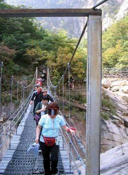 South Korean tourists cross a suspension bridge spanning a picturesque gorge at the Mount Kumgang resort in 2005. (AFP/File/Charles Whelan)