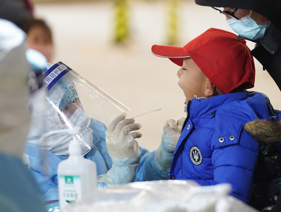 A child is given a nucleic acid test for COVID-19 in Beijing’s Daxing District on January 20, 2021.