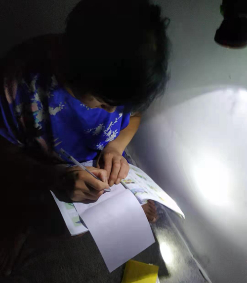 A construction worker practices writing in the dormitory. Photo courtesy of the interviewee
