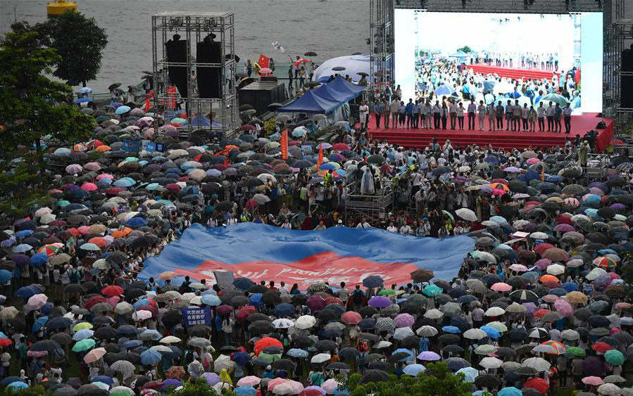 Local residents take part in the "Safeguard Hong Kong" massive rally in south China