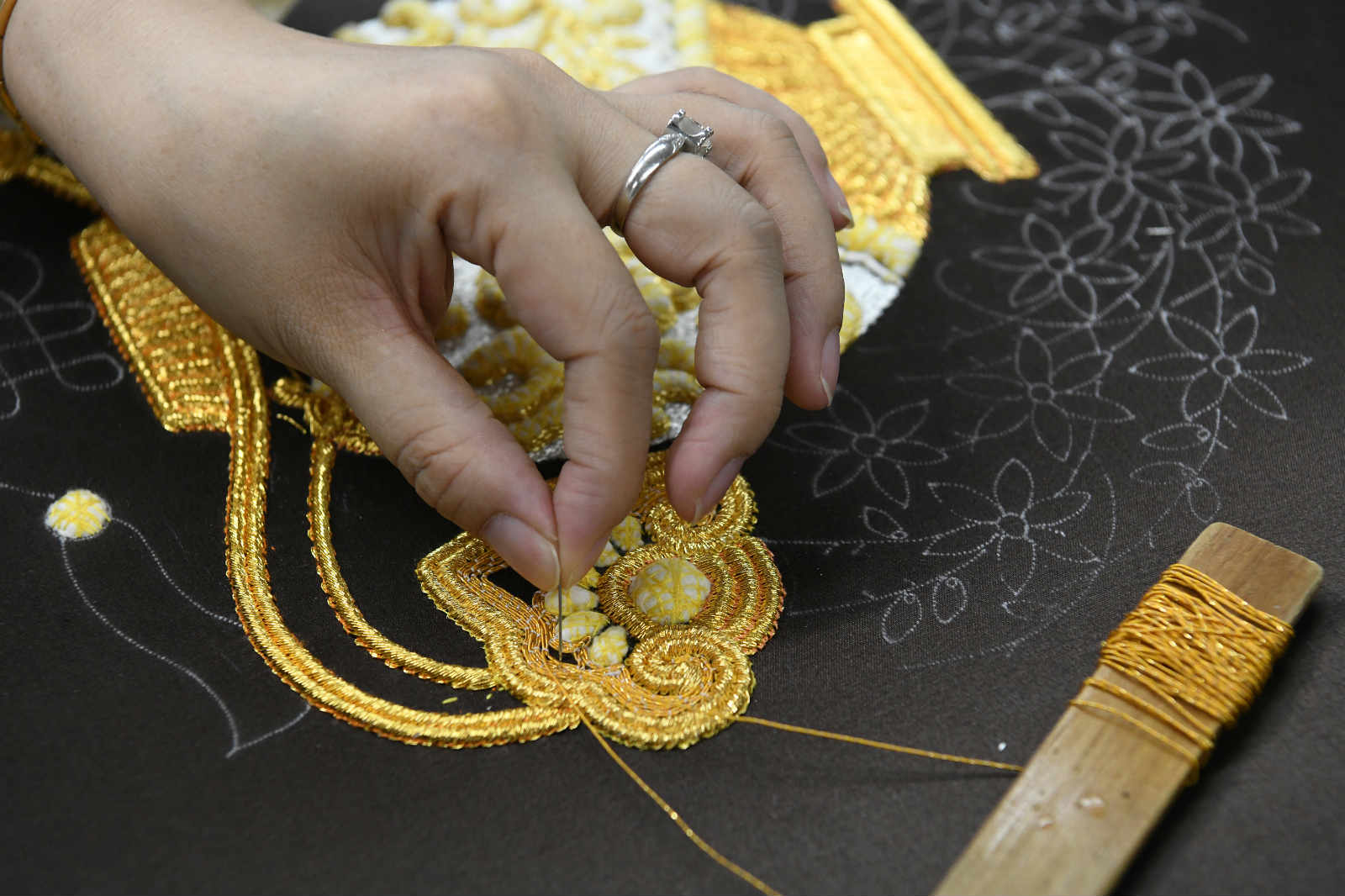 She Keyan, the official heir to the national heritage of Chao Embroidery, works on a piece of Chao Embroidery at her workshop in Chaozhou, south China