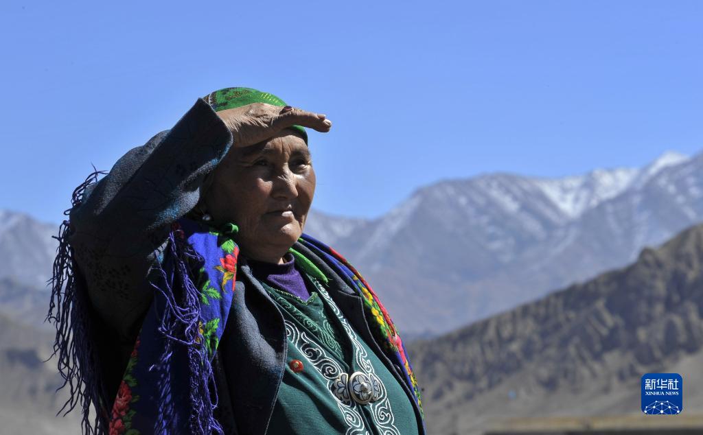 在新疆乌恰县吉根乡，布茹玛汗·毛勒朵遥望边境线上的雪山（2012年10月1日摄）。新华社记者 江文耀 摄