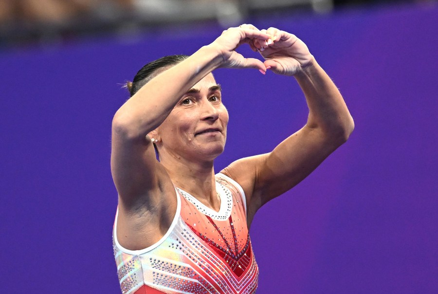 Oksana Chusovitina of Uzbekistan acknowledges the spectators after competing in the Vault of Artistic Gymnastics Women